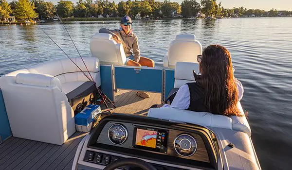 2 women cruising on a lake in a godfrey sweetwater tritoon