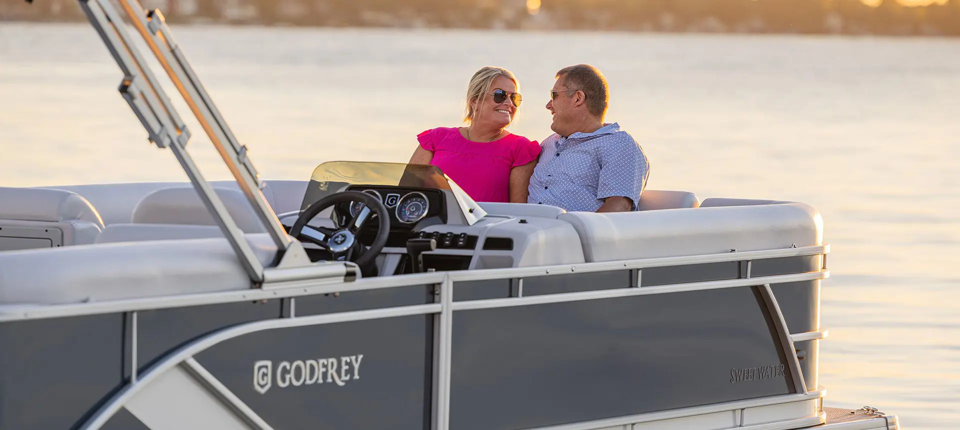 woman relaxing on the swingback seat on a godfrey sweetwater pontoon