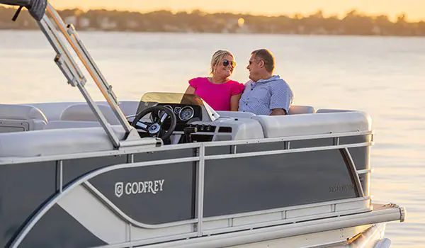 woman relaxing on the swingback seat on a godfrey sweetwater pontoon
