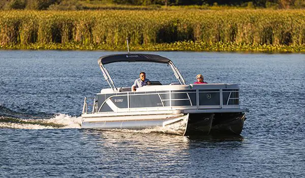 couple relaxing on a docked godfrey sweetwater pontoon