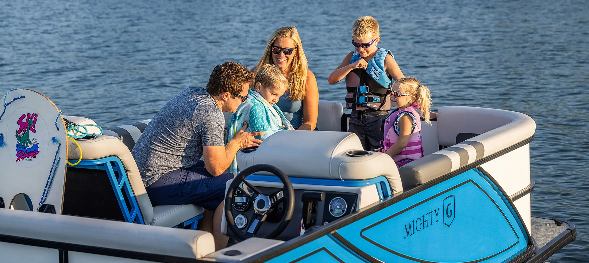 Family drying off on a Godfrey Mighty G Cruise pontoon boat.