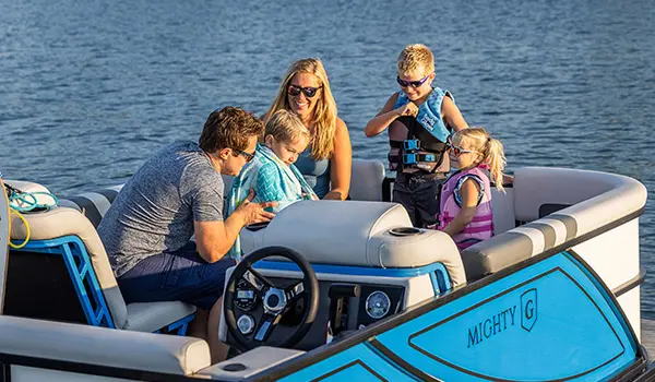 Family drying off on a Godfrey Mighty G Cruise pontoon boat.