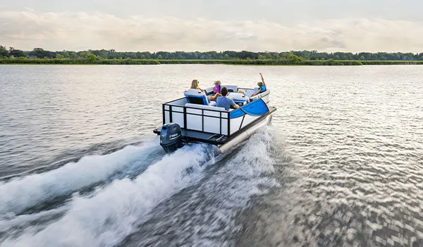Family on a Godfrey Mighty G Cruise pontoon boat cruising the lake.