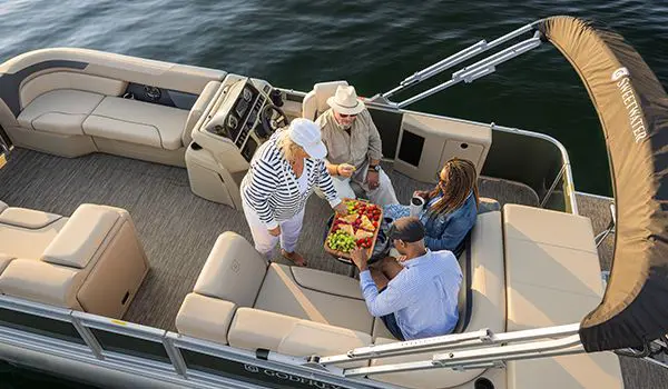 Aerial view of a 4 people having a fruit snack at the stern table.