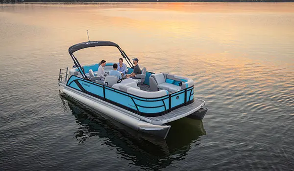 Aerial view of 4 people sitting at the stern table on a Godfrey Sweetwater Entertainment pontoon boat.
