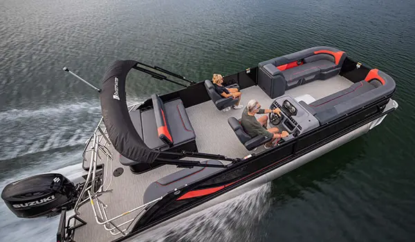 Aerial view of a couple cruising the lake on their Godfrey Sweetwater Lounge pontoon boat.