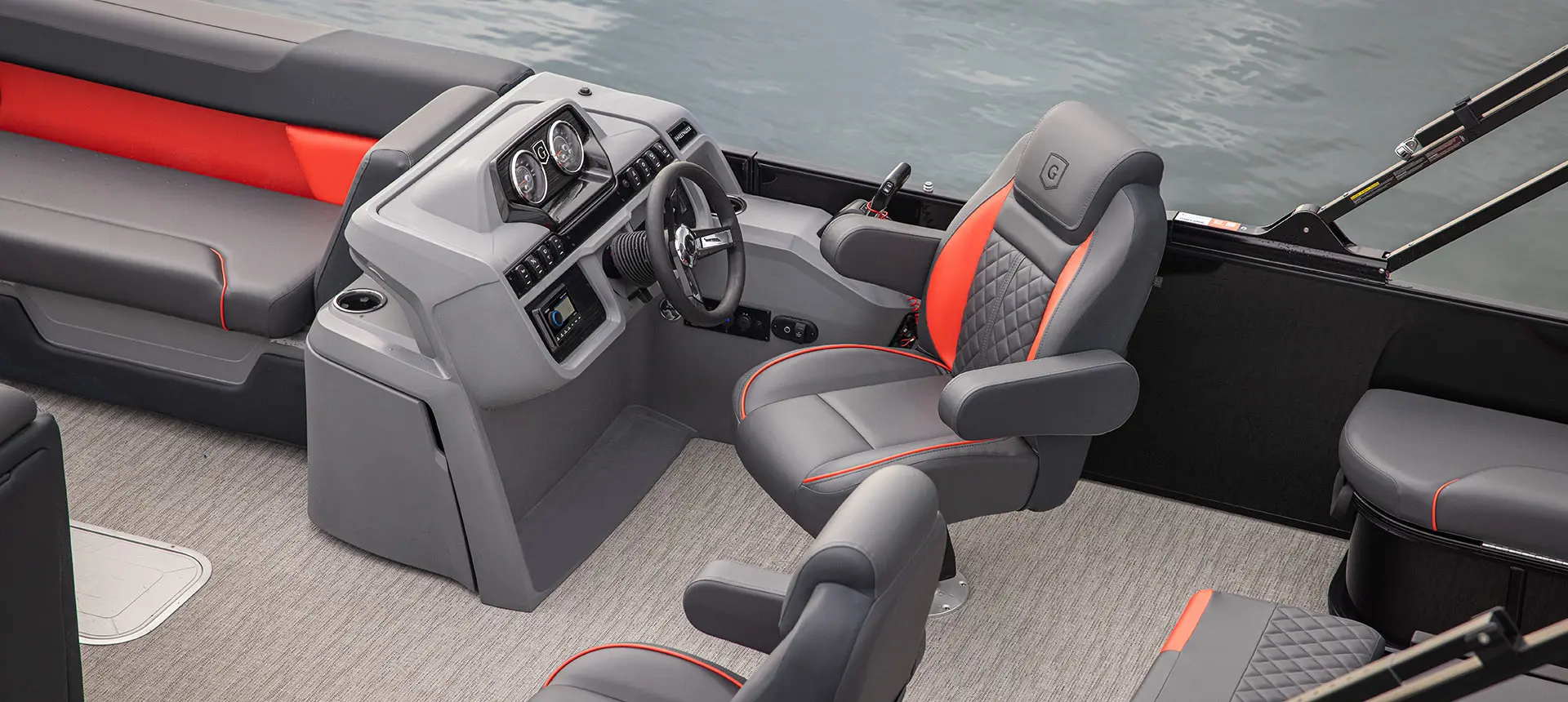 Captain's chair at the helm of a Godfrey Sweetwater Lounge pontoon boat.