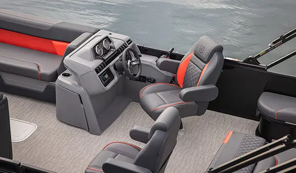 Captain's chair at the helm of a Godfrey Sweetwater Lounge pontoon boat.