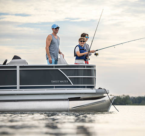 Family fishing off of the front-end of a parked Godfrey Sweetwater Special Edition pontoon.