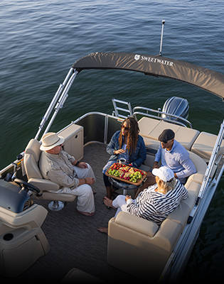 Overhead view of group of friends having snacks on a parked Godfrey Sweetwater Special Edition pontoon.