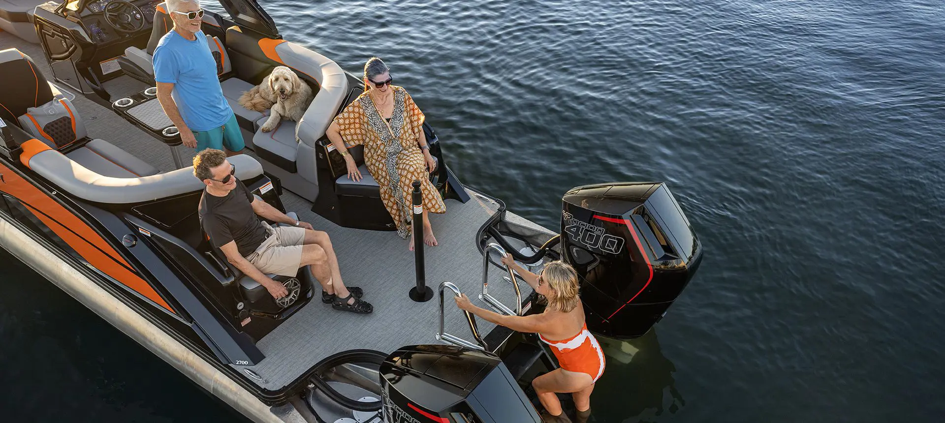 Woman climbing down the stern ladder of a Godfrey XP Tritoon boat.