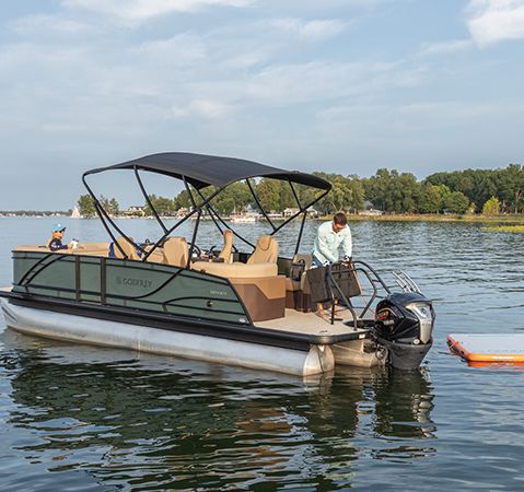 Parked pontoon with a inflatable Godfrey swim mat.