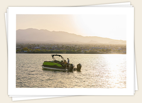 A family enjoying the lake with their durable and high-performance Godfrey pontoon boat.