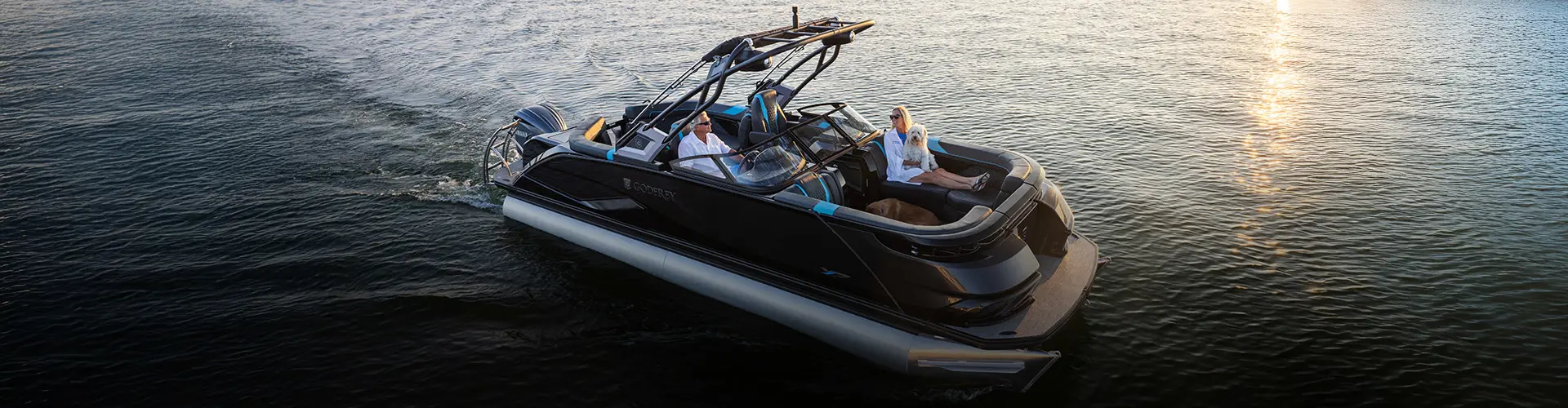 Couple riding on adjustable boat seats on a Godfrey pontoon boat. 
