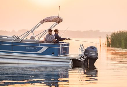 2 men fishing off the stern of a Godfrey Xperience pontoon boat.