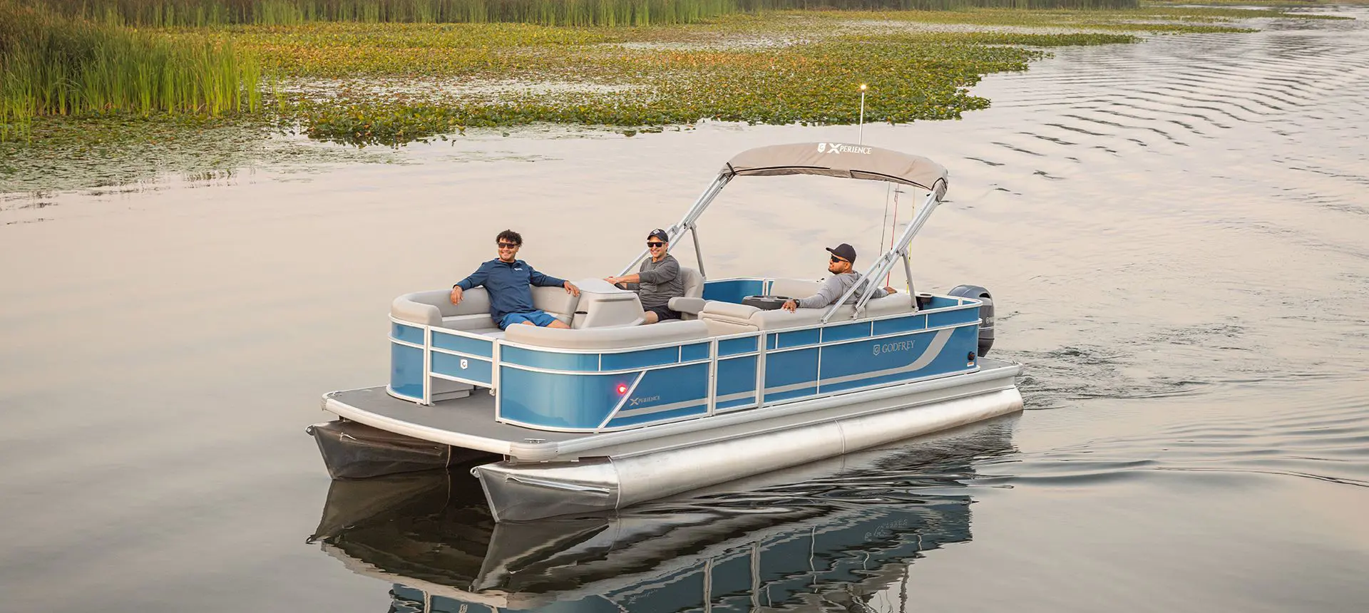 3 men enjoying their time on a lake with a Godfrey Xperience pontoon boat.