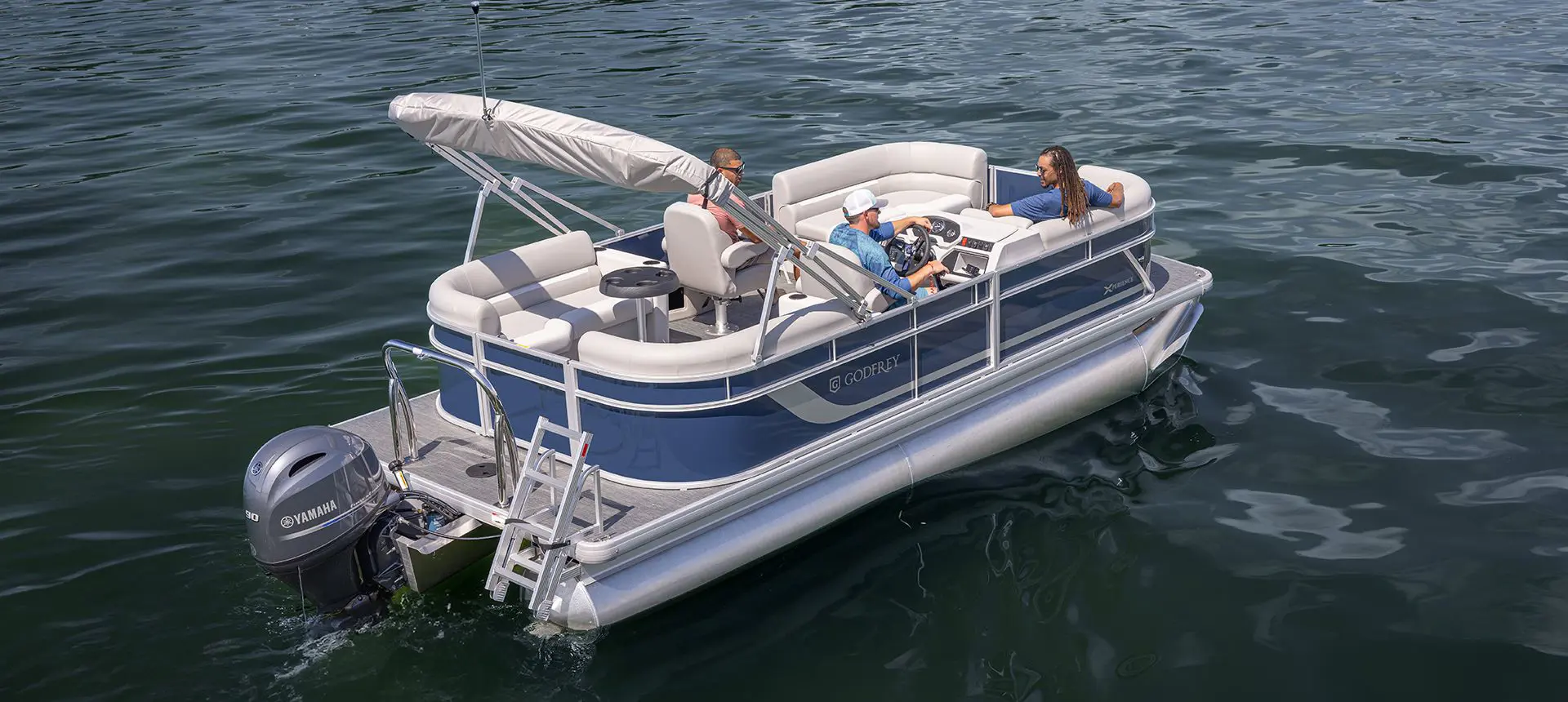 Stern focused view of a Godfrey Xperience pontoon boat on a lake.