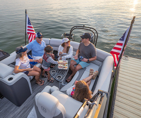Friends and family lounge on rear seating on a Godfrey Entertainment Pontoon Boat.
