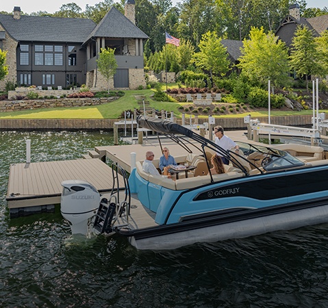 People relaxing on the Stern Ultra Lounge of a Godfrey pontoon boat with a Stern Ultra Lounge (UL) layout.