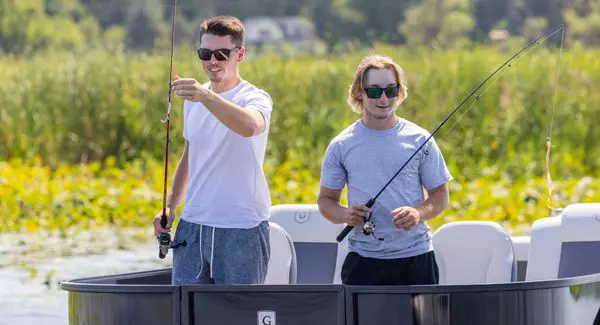 2 guys fishing off the bow of a Godfrey Mighty G pontoon boat.