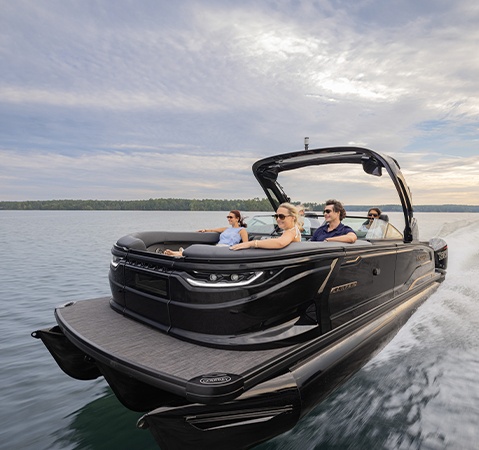 A Godfrey Sanpan pontoon boat cruising across a lake and showcasing it's 1,000 horsepower with twin engines.
