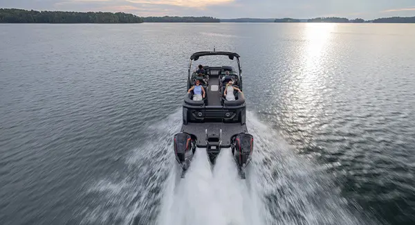 Stern-focused view of a Godfrey Sanpan pontoon boat cruising on a lake.