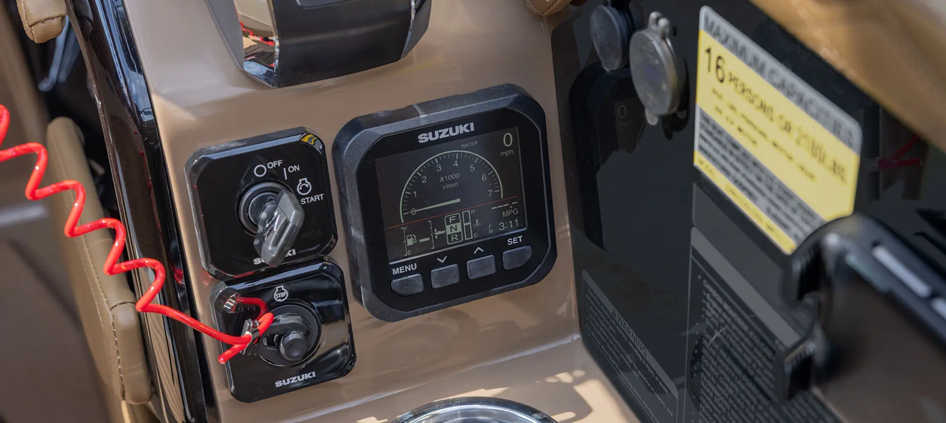 Ignition and other gauges on the helm of a Godfrey Sanpan pontoon boat.