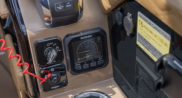 Ignition and other gauges on the helm of a Godfrey Sanpan pontoon boat.