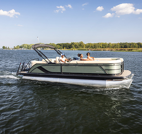 A Godfrey Sweetwater pontoon boat cruising across a lake.