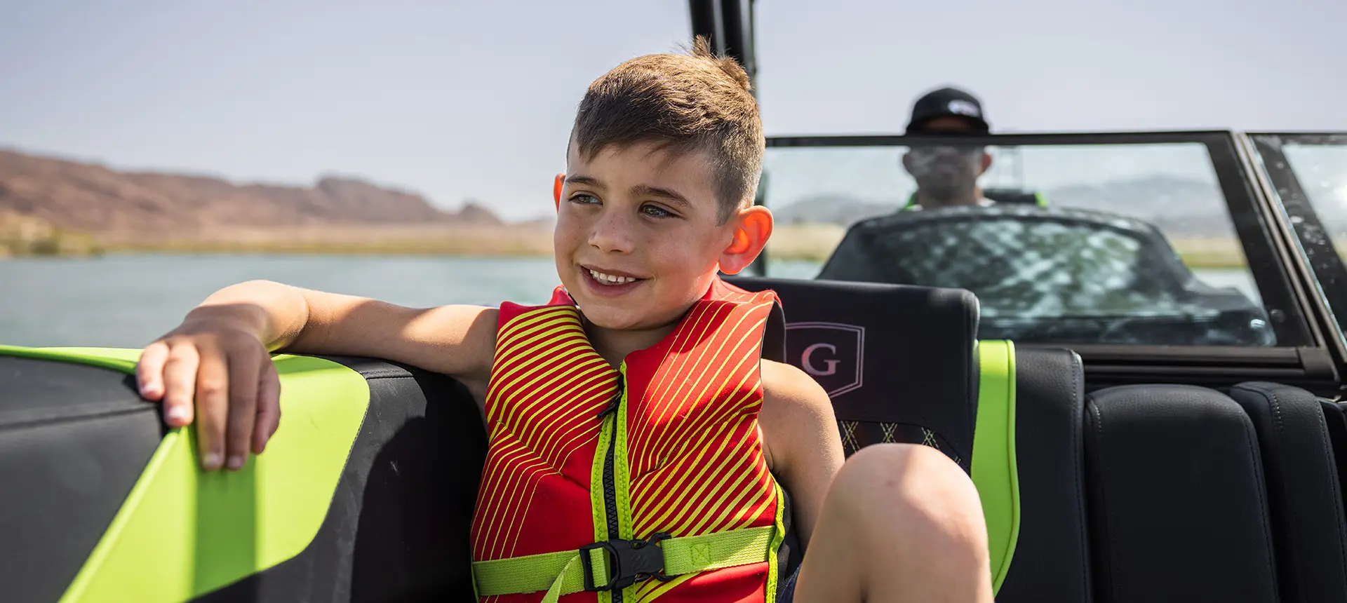 Closeup of a young boy having a nice time on a Godfrey XP tritoon boat.