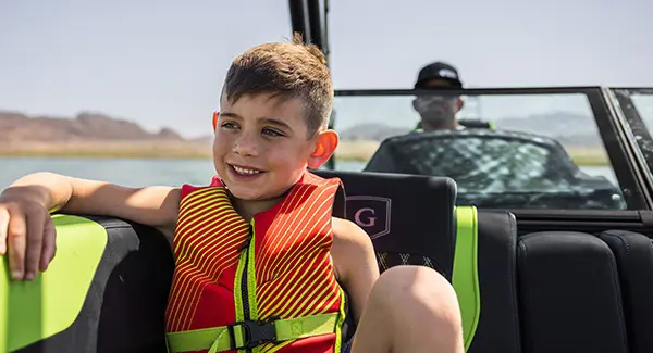 Closeup of a young boy having a nice time on a Godfrey XP tritoon boat.