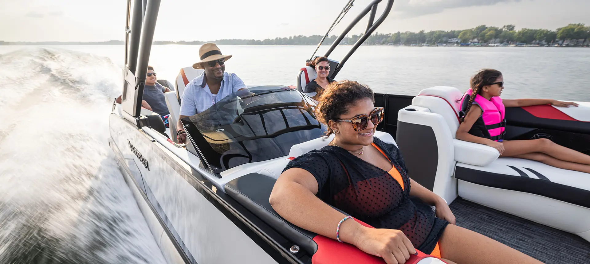 5 people cruising the lake on a Godfrey XP tritoon boat.