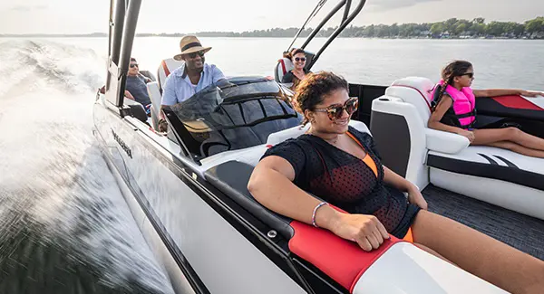 5 people cruising the lake on a Godfrey XP tritoon boat.