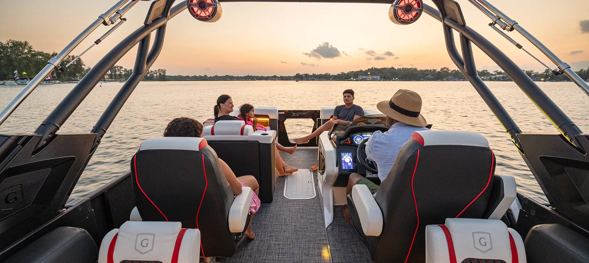 5 people enjoying the JBL sound system on a Godfrey XP tritoon boat.