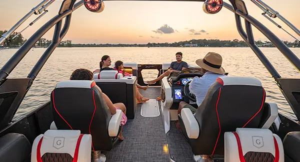 5 people enjoying the JBL sound system on a Godfrey XP tritoon boat.