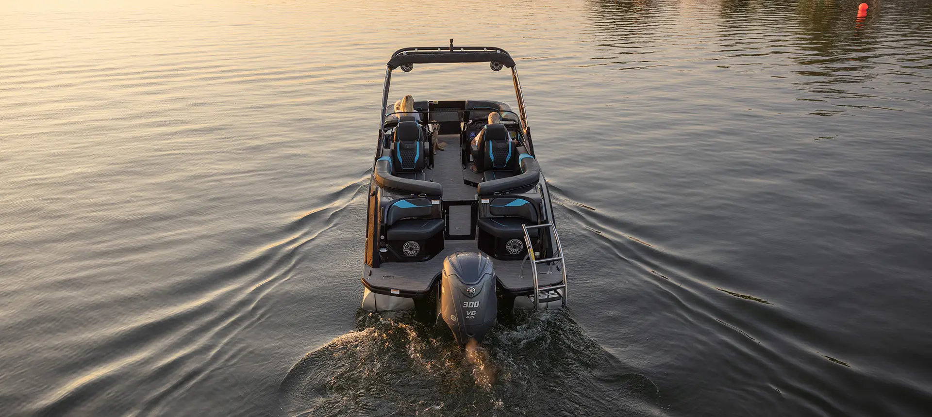 Stern focused view of a Godfrey XP tritoon boat on a lake.