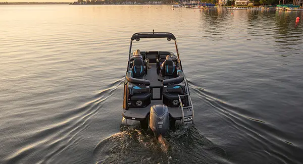 Stern focused view of a Godfrey XP tritoon boat on a lake.