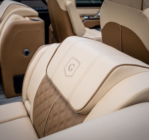 Closeup of the detailed embroidery on the seat of a Godfrey pontoon boat.