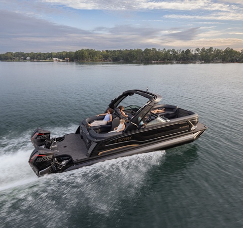 5 people cruising a lake on a Godfrey Sanpan pontoon boat.