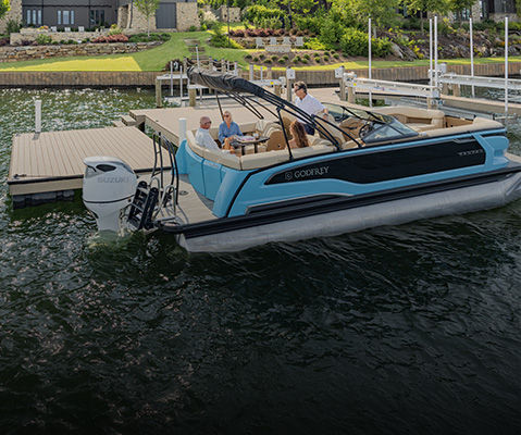 People relaxing on the Stern Ultra Lounge of a Godfrey pontoon boat with a Stern Ultra Lounge (UL) layout.