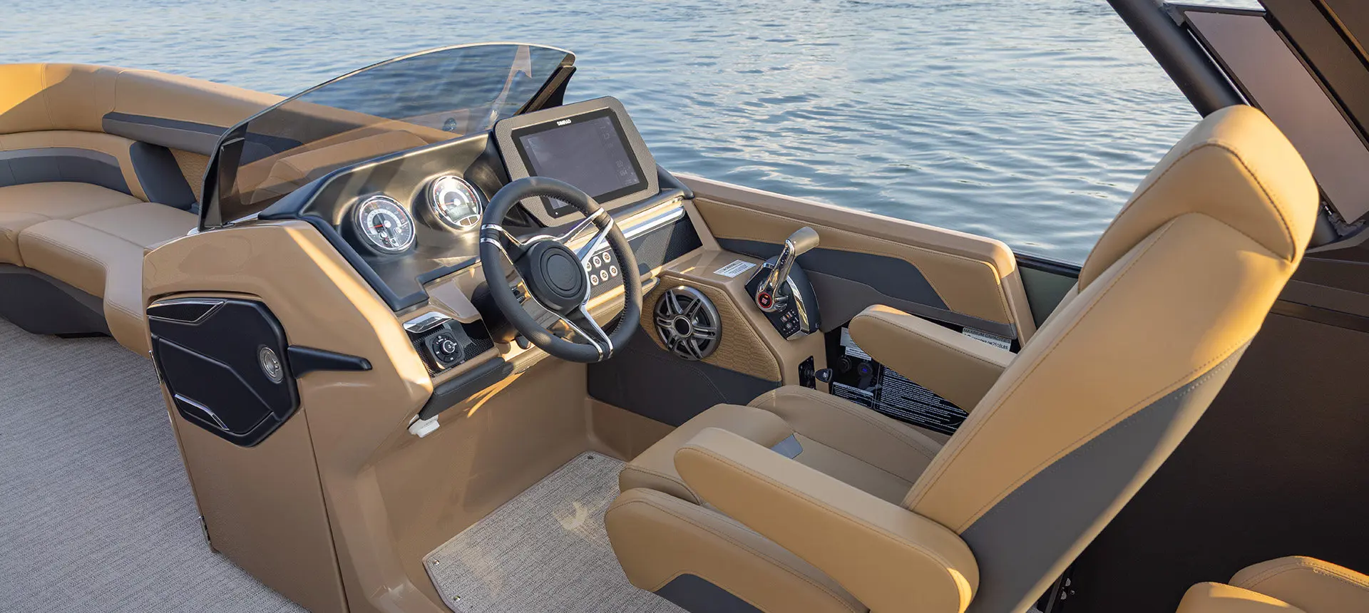 Closeup of the helm and captain's chair on a Godfrey AquaPatio pontoon boat.