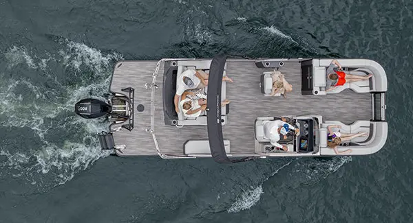 Aerial view of a Godfrey AquaPatio pontoon boat cruising on a lake.