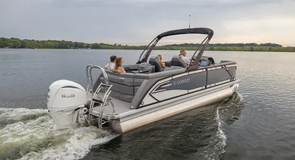 Rear view of a Godfrey AquaPatio pontoon boat cruising on a lake.