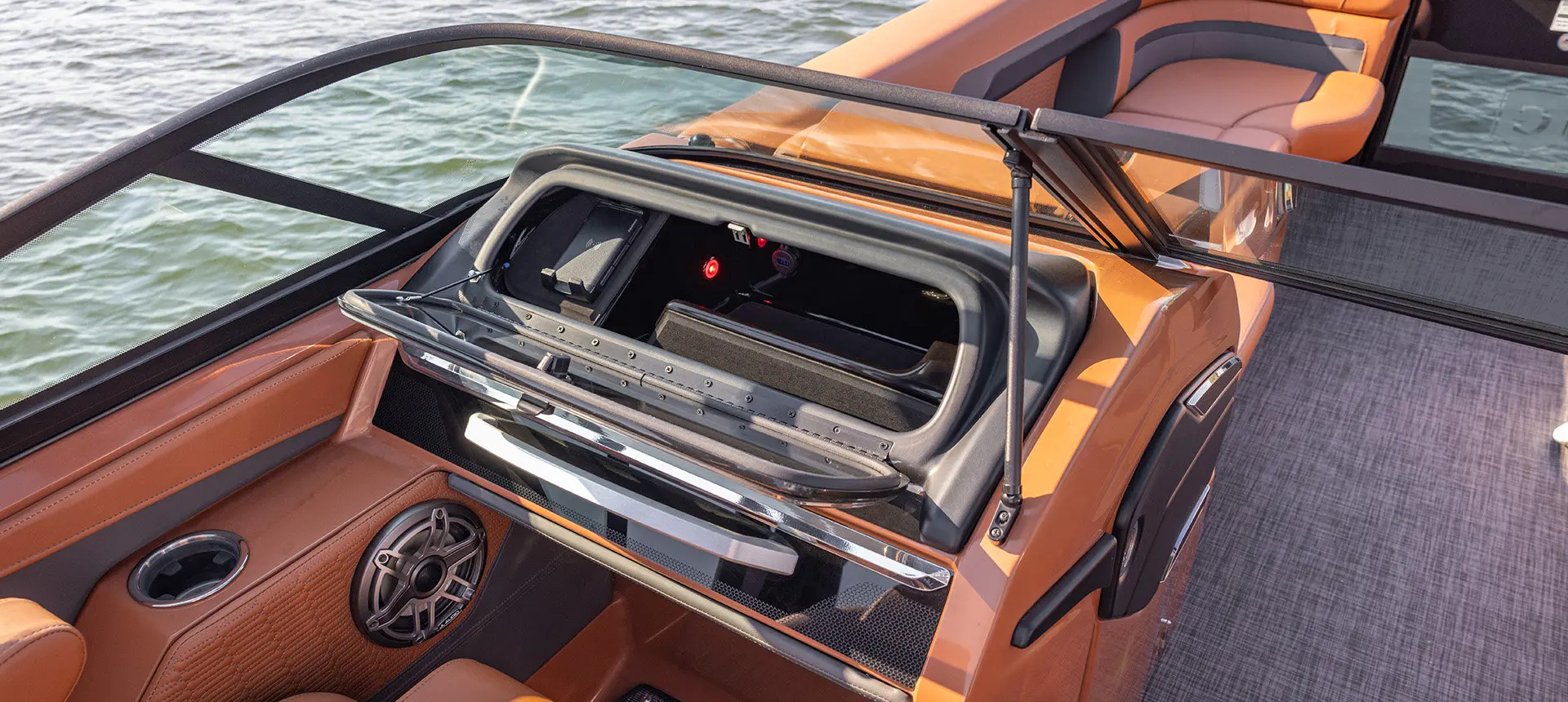 Integrated storage behind the windshield on a Godfrey AquaPatio pontoon boat.