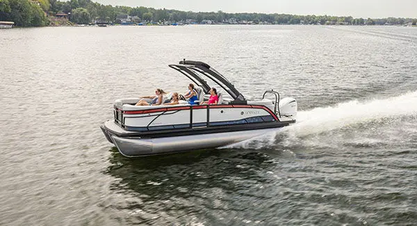 People cruising a lake on a Godfrey Monaco pontoon boat.