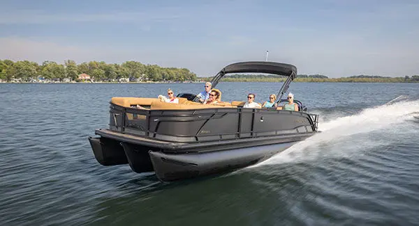 6 people crusing the lake on a Godfrey Monaco pontoon boat.