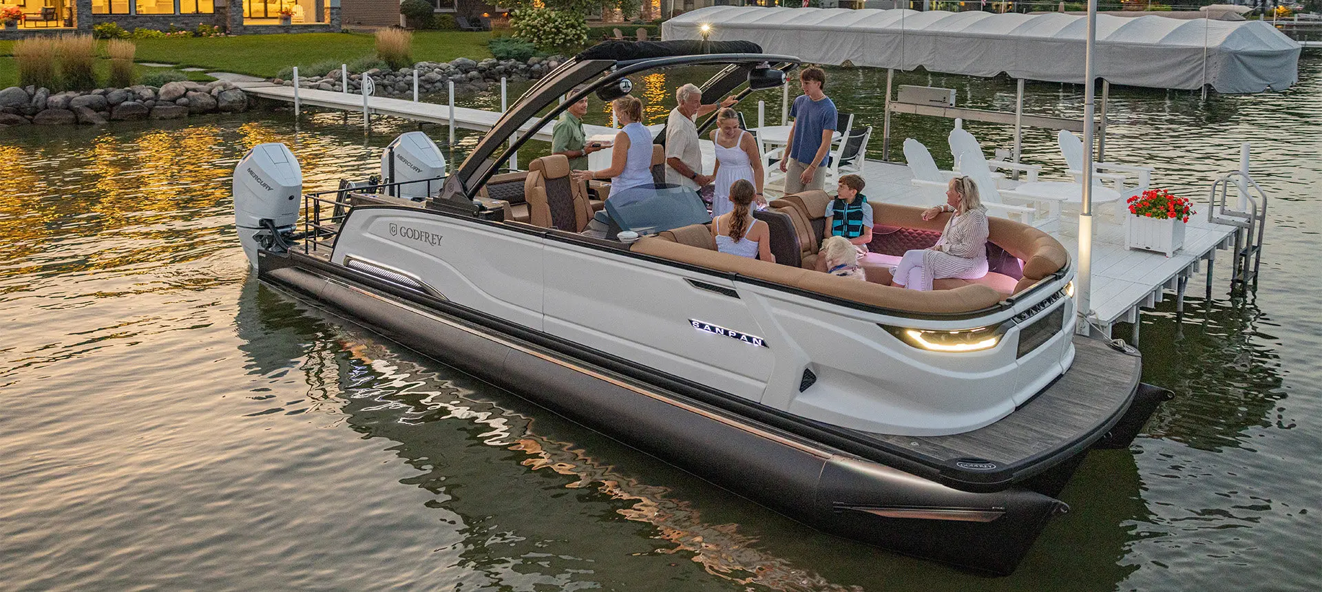 8 people and a dog getting ready for a lake cruise on a Godfrey Sanpan pontoon boat.
