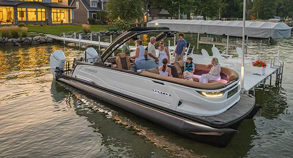 8 people and a dog getting ready for a lake cruise on a Godfrey Sanpan pontoon boat.