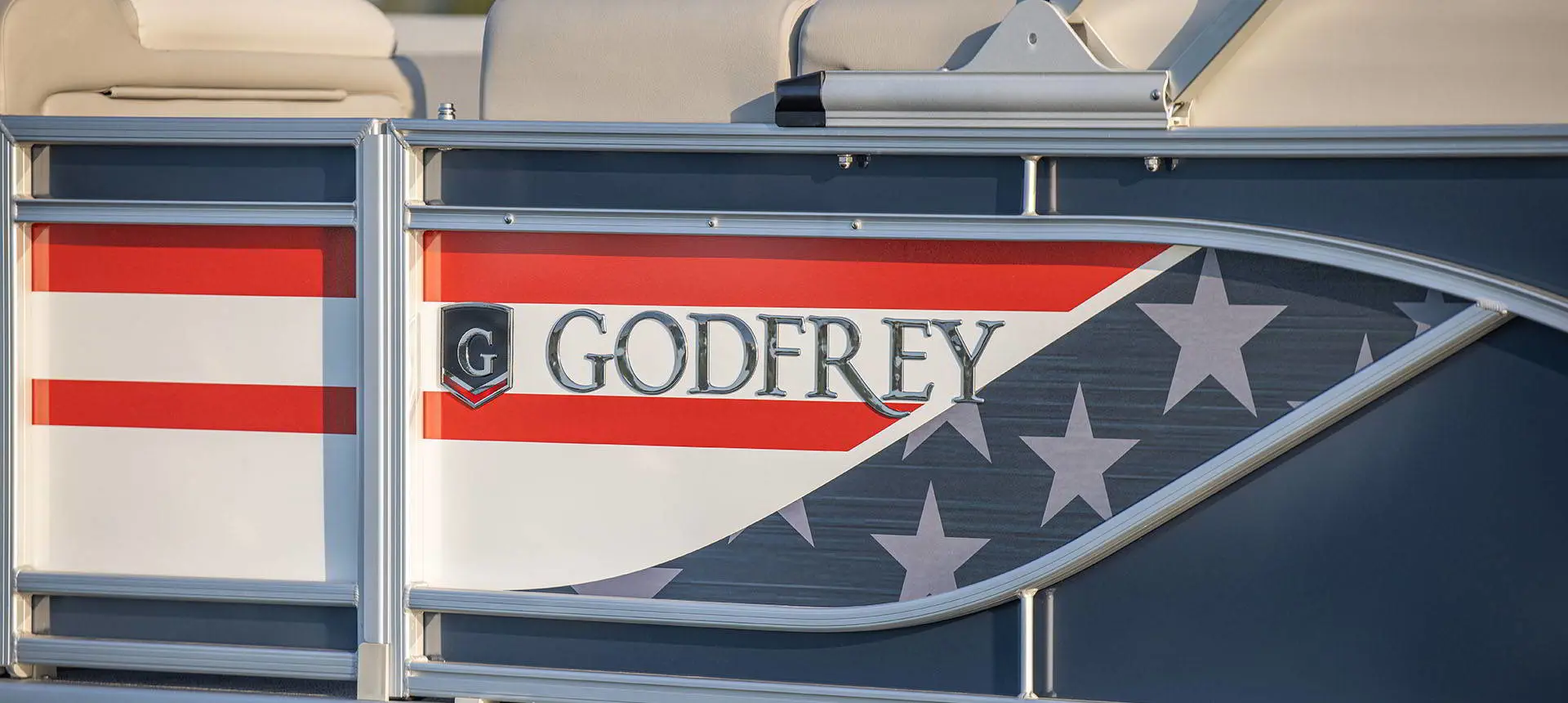 American flag branding on the side of a Godfrey AquaPatio pontoon boat.