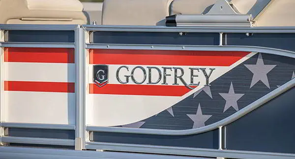 American flag branding on the side of a Godfrey AquaPatio pontoon boat.